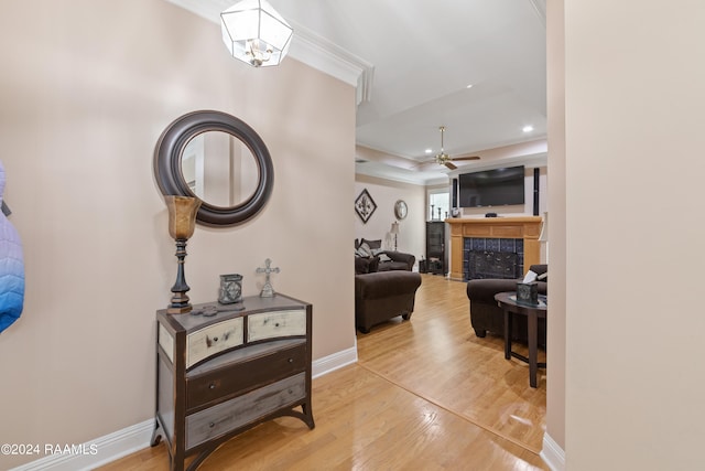 hallway featuring crown molding and light hardwood / wood-style floors