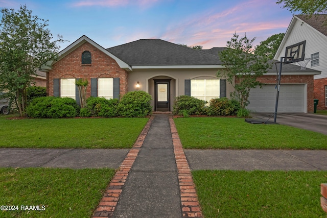 view of front facade with a lawn and a garage