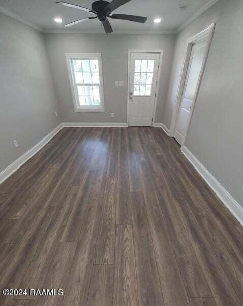 spare room featuring ornamental molding, ceiling fan, and dark hardwood / wood-style floors