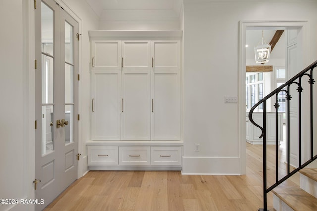 mudroom with a chandelier and light hardwood / wood-style flooring