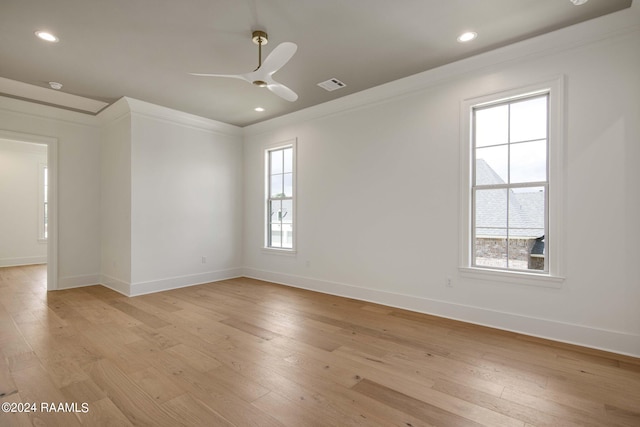 spare room with ceiling fan, light wood-type flooring, and plenty of natural light