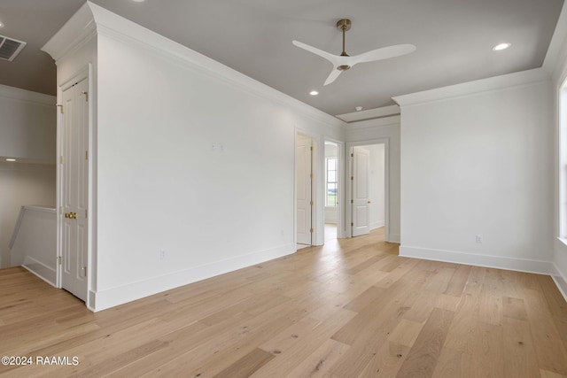 unfurnished room featuring ceiling fan, light wood-type flooring, and ornamental molding