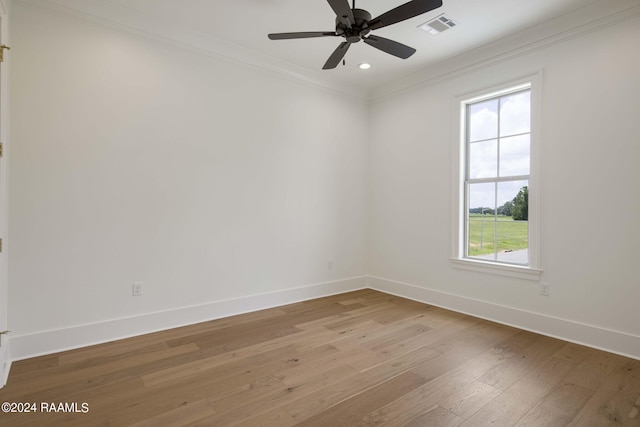 unfurnished room featuring ceiling fan, a wealth of natural light, ornamental molding, and light hardwood / wood-style floors