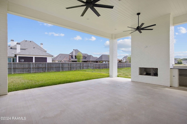 view of patio / terrace with ceiling fan and an outdoor brick fireplace