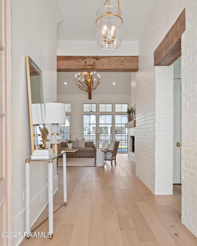 225 Gunter Grass Ct, Lafayette, LA 70508 - corridor with light wood-style flooring, brick wall, a chandelier, and beamed ceiling