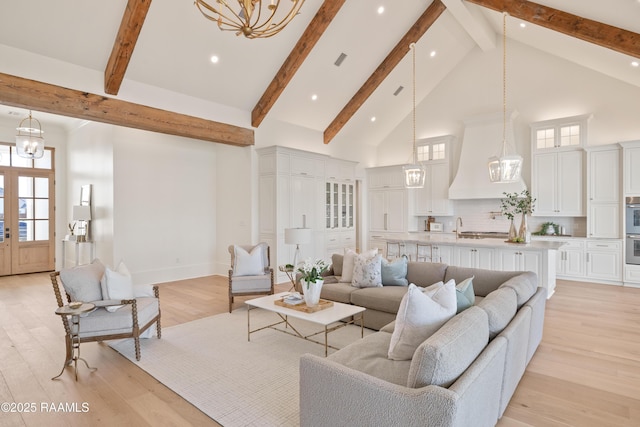 225 Gunter Grass Ct, Lafayette, LA 70508 - living area with high vaulted ceiling, light wood-style floors, beamed ceiling, visible vents, and a notable chandelier