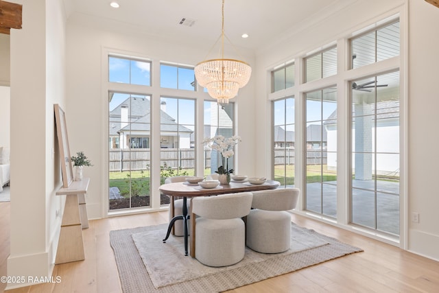 225 Gunter Grass Ct, Lafayette, LA 70508 - dining room with light wood-type flooring, visible vents, ornamental molding, and a chandelier
