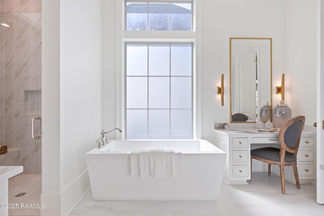 225 Gunter Grass Ct, Lafayette, LA 70508 - bathroom featuring marble finish floor, vanity, a freestanding tub, and a stall shower