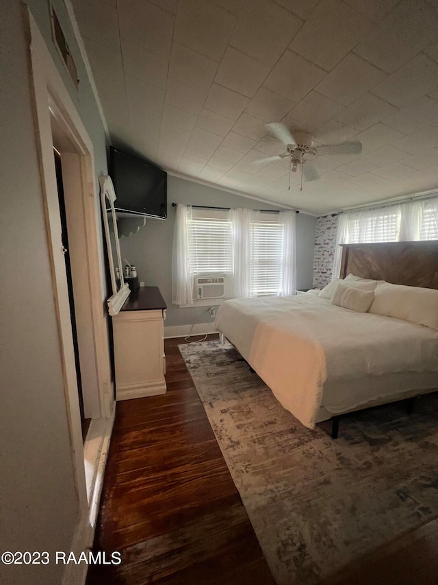 bedroom with dark hardwood / wood-style flooring, multiple windows, and ceiling fan