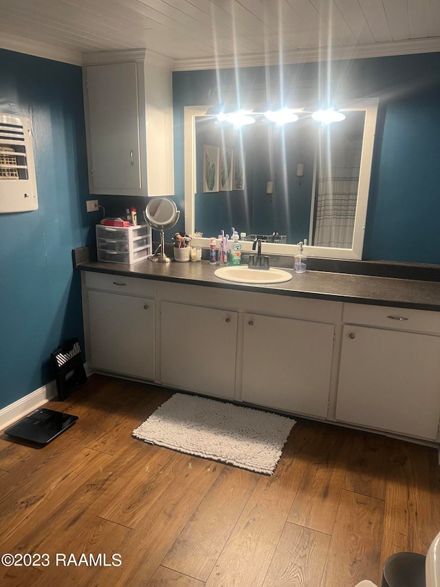 kitchen with white cabinets, wood-type flooring, and sink