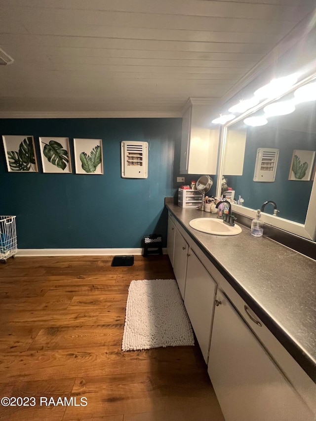 bathroom with vanity, crown molding, and hardwood / wood-style flooring