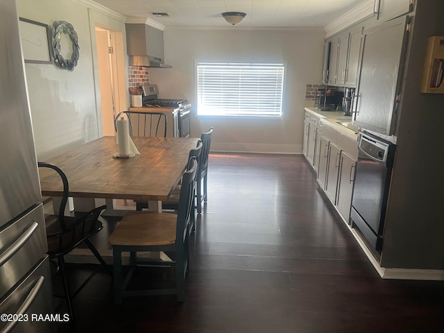 dining area with crown molding and dark hardwood / wood-style flooring