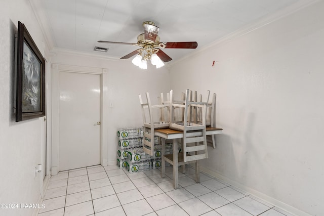 tiled dining space featuring ceiling fan and crown molding