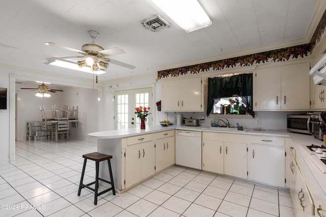 kitchen with light tile flooring, kitchen peninsula, dishwasher, ceiling fan, and sink