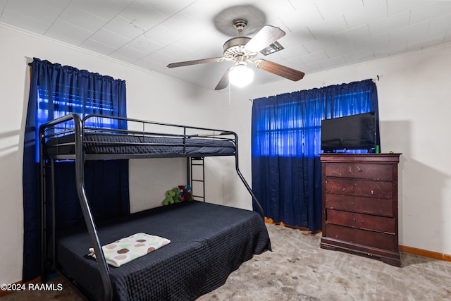 carpeted bedroom with ceiling fan and crown molding