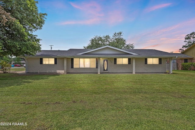 ranch-style house featuring a yard