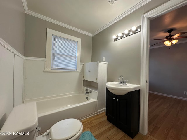 bathroom with ceiling fan, toilet, vanity, hardwood / wood-style flooring, and ornamental molding