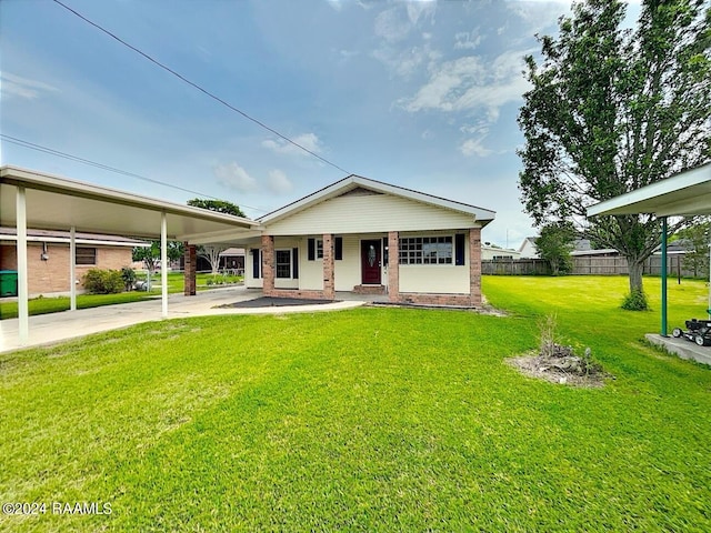 view of front of house with a front yard and a carport