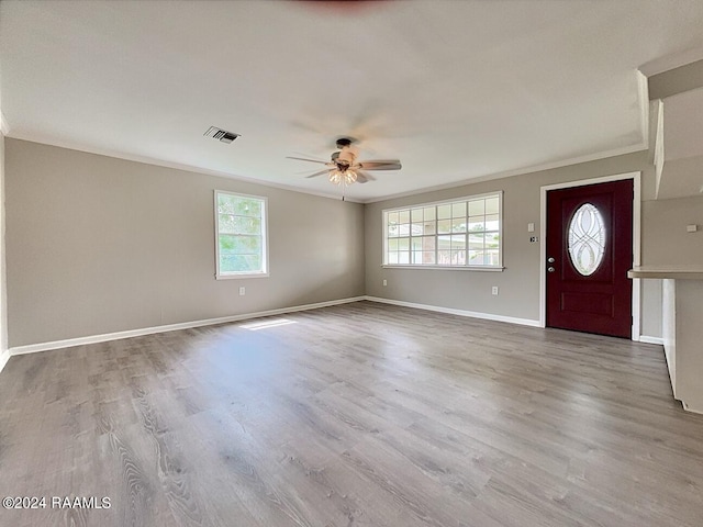 entrance foyer featuring ceiling fan, crown molding, and hardwood / wood-style flooring