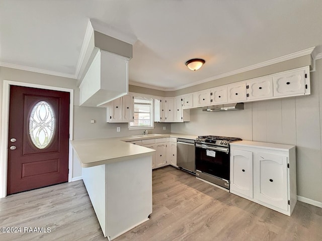 kitchen with white cabinets, appliances with stainless steel finishes, kitchen peninsula, and light wood-type flooring