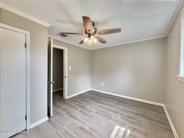 unfurnished room with ornamental molding, ceiling fan, hardwood / wood-style flooring, and a textured ceiling