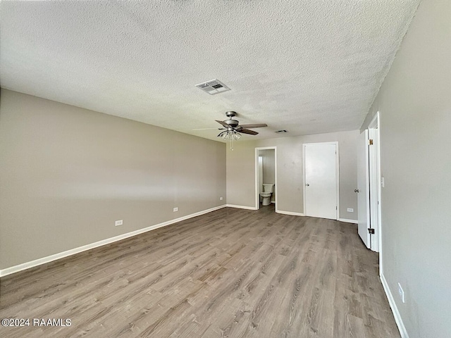 empty room featuring wood-type flooring, a textured ceiling, and ceiling fan