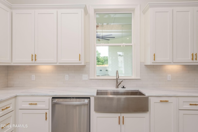 kitchen with sink, white cabinetry, stainless steel dishwasher, and decorative backsplash