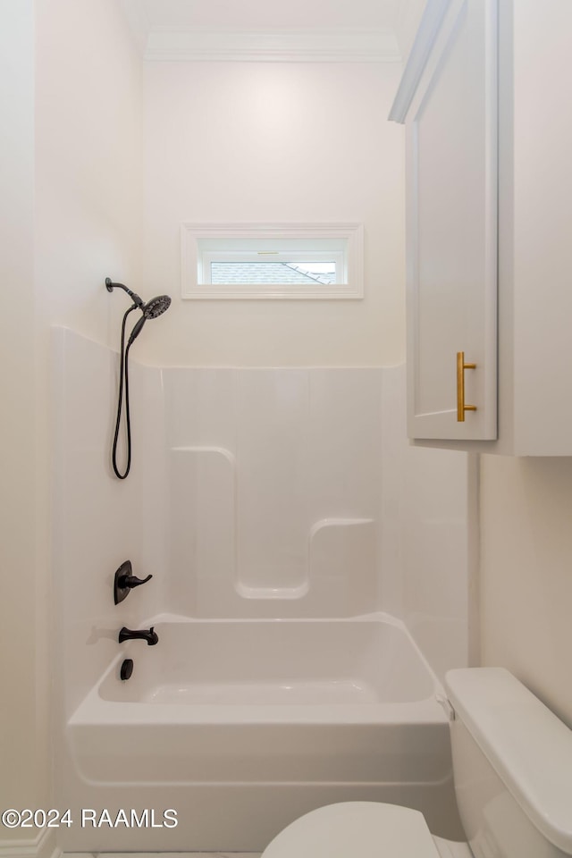 bathroom featuring toilet, ornamental molding, and shower / washtub combination