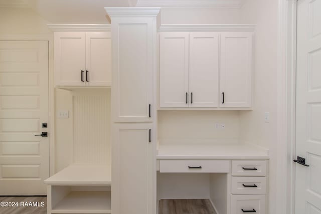 mudroom featuring hardwood / wood-style flooring and crown molding