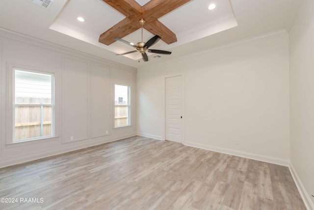 spare room with a wealth of natural light, light wood-type flooring, ornamental molding, and coffered ceiling