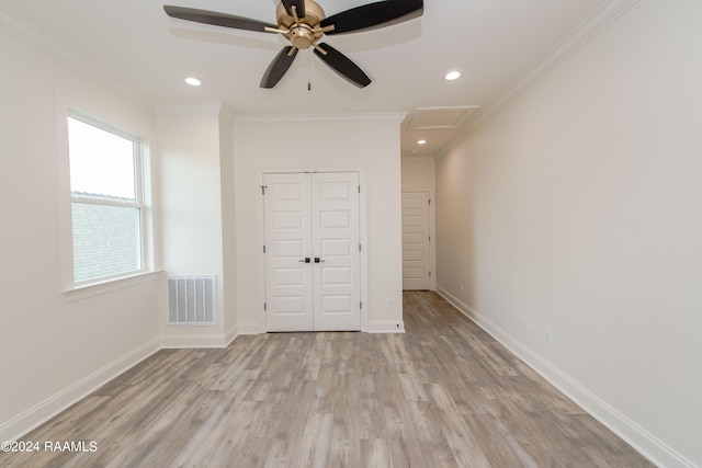 unfurnished bedroom with a closet, ceiling fan, light hardwood / wood-style floors, and crown molding