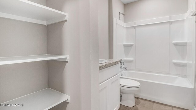 full bathroom with tile patterned floors, vanity, shower / bath combination, and toilet