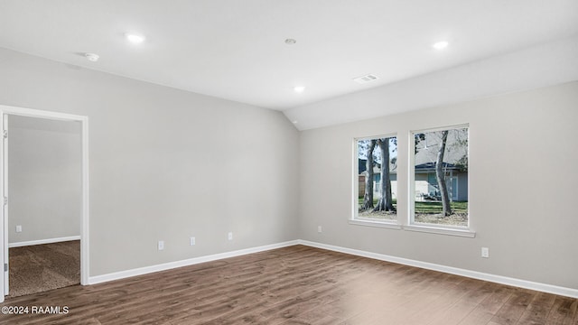 empty room featuring hardwood / wood-style flooring and lofted ceiling