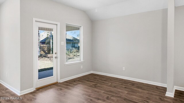 spare room with dark hardwood / wood-style floors and lofted ceiling