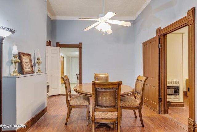 dining area with crown molding, light hardwood / wood-style flooring, and ceiling fan