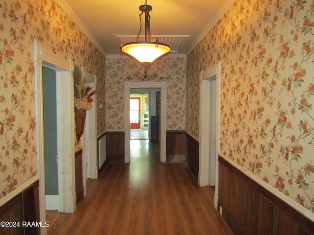 corridor with dark hardwood / wood-style flooring and ornamental molding