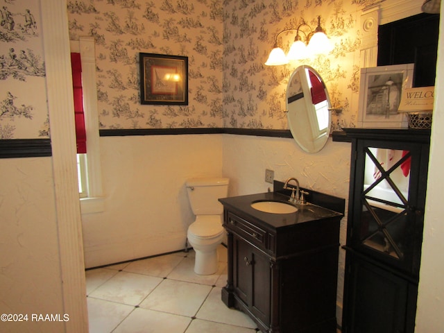 bathroom featuring tile patterned flooring, vanity, and toilet