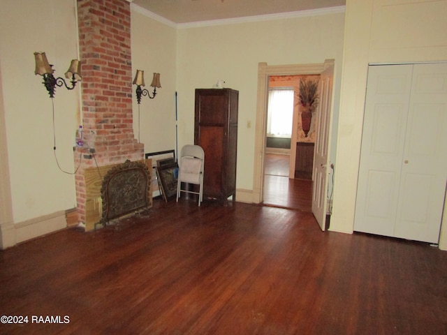 unfurnished living room featuring dark hardwood / wood-style floors and ornamental molding