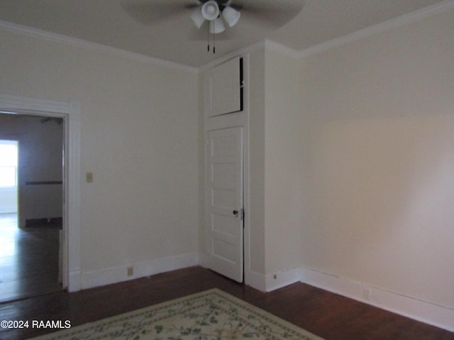 unfurnished room featuring dark hardwood / wood-style floors, ceiling fan, and crown molding