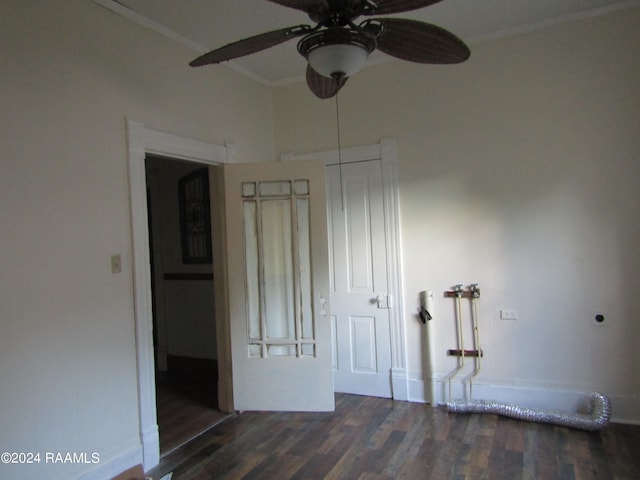 empty room featuring ceiling fan, dark hardwood / wood-style flooring, and ornamental molding