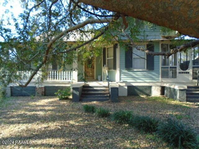 view of front of house with a sunroom