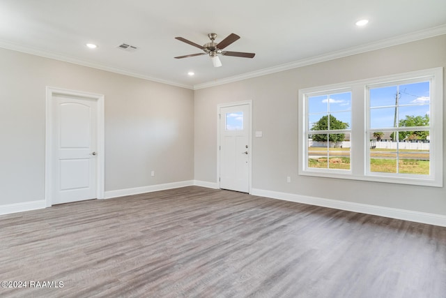 interior space with ceiling fan, ornamental molding, and hardwood / wood-style floors