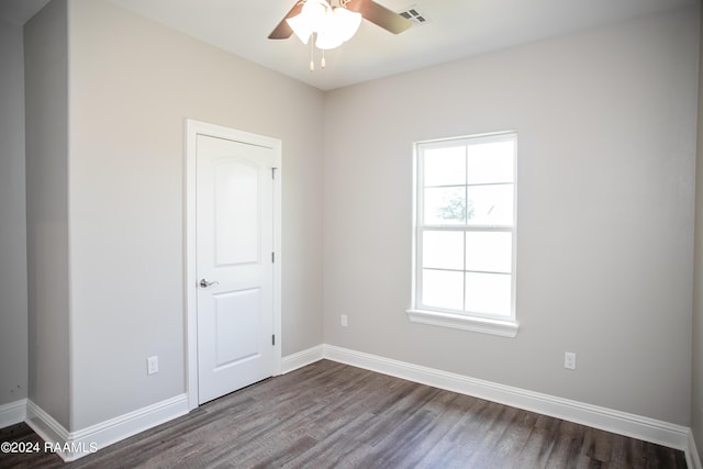 unfurnished room with ceiling fan and dark hardwood / wood-style flooring