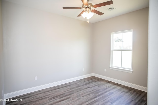 spare room with ceiling fan and dark wood-type flooring