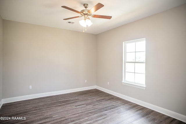 spare room with ceiling fan, dark hardwood / wood-style flooring, and plenty of natural light