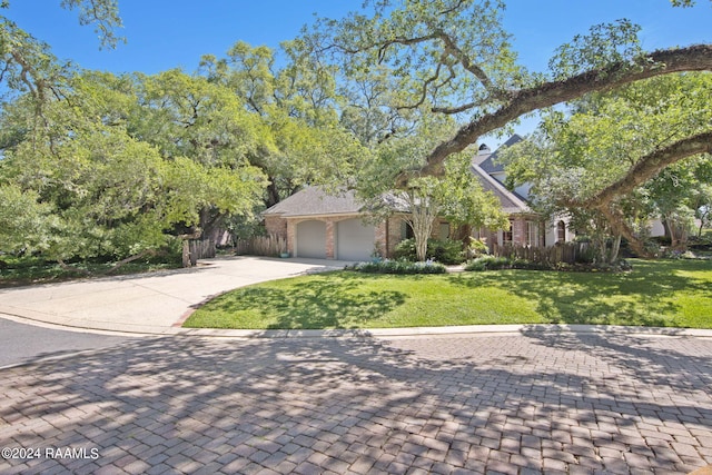 view of front of property with a front lawn and a garage