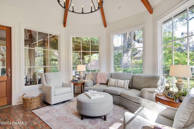 sunroom featuring a notable chandelier and vaulted ceiling with beams