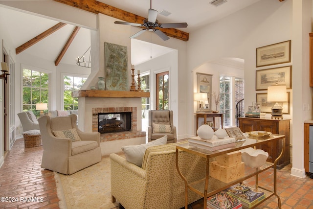 living room with beam ceiling, high vaulted ceiling, a fireplace, and ceiling fan