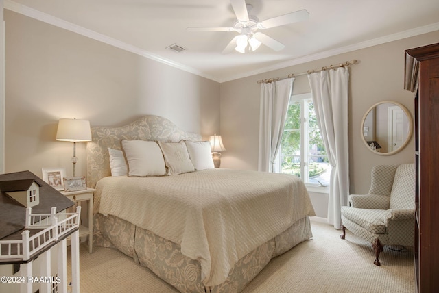 carpeted bedroom with ceiling fan and crown molding