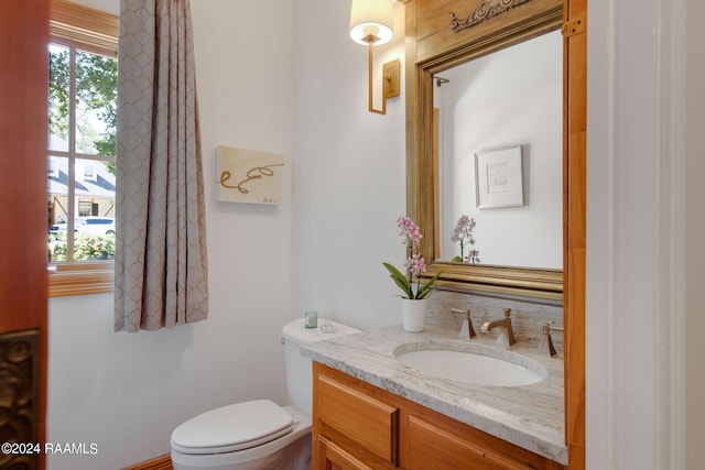 bathroom featuring large vanity and toilet